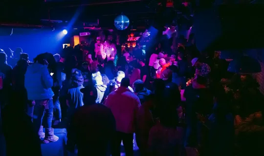 a group of people standing in a dark room