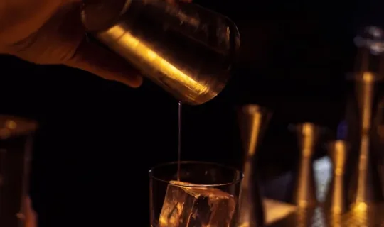 person holding clear drinking glass
