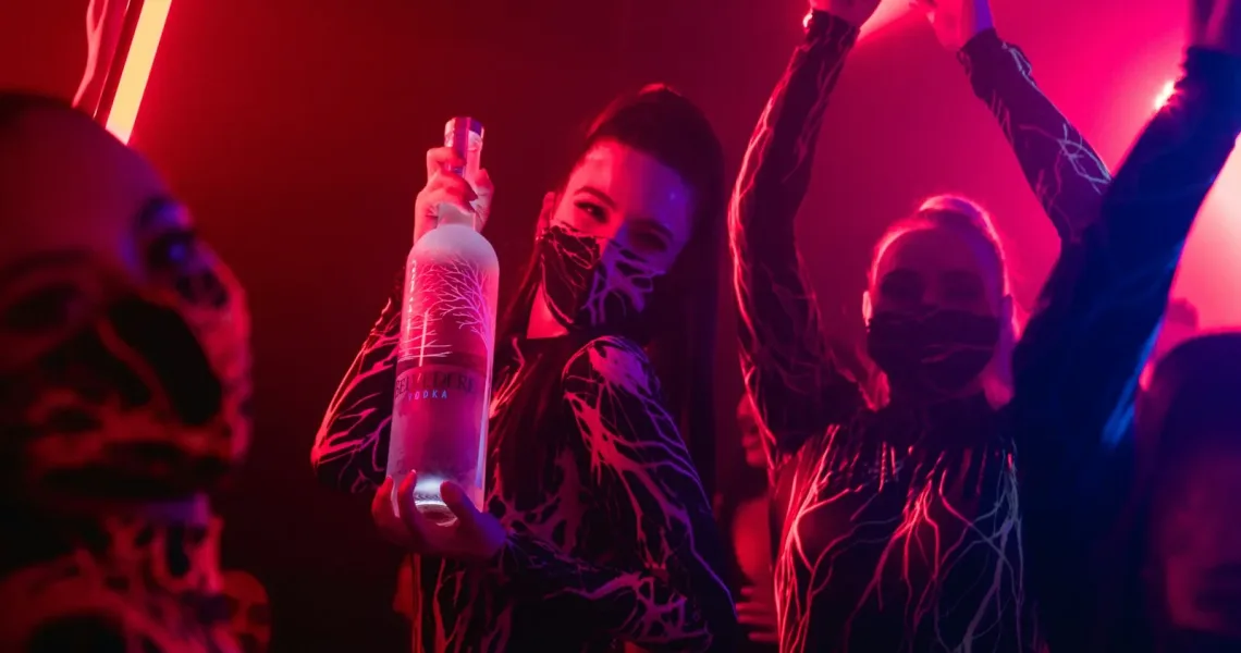 a group of people holding bottles