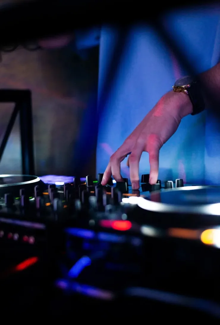 a dj mixing music in a dark room